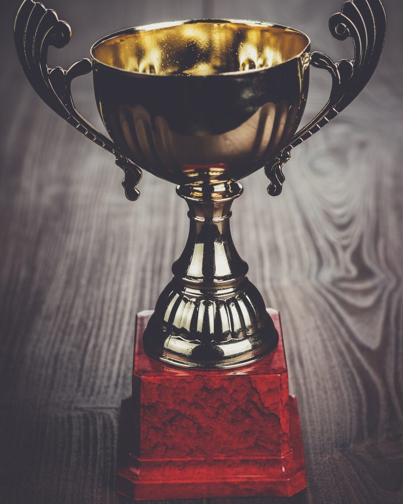 trophy-cup-the-brown-wooden-table.jpg